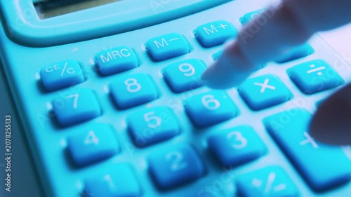 POV macro of an AI robotic hand pressing buttons on an office calculator. 