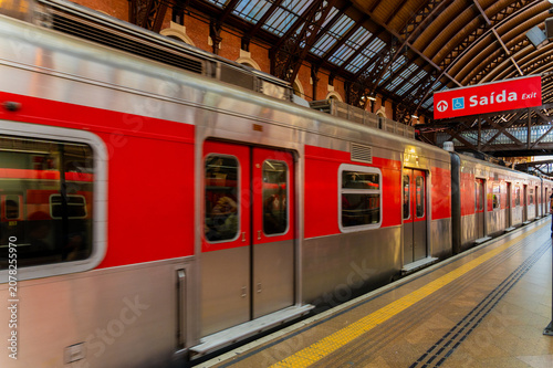 Red passenger train arriving at Luz station platform in Sao Paulo Brazil