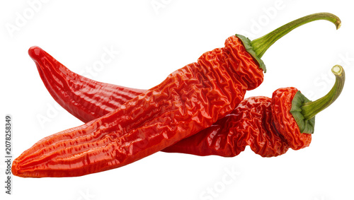 Schilderij op canvas Isolated two red dried shrivelled chili peppers, hot ingredient for cooking and