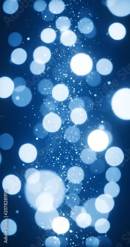 Floating blue bokeh light particles shimmering on a dark abstract background loop.