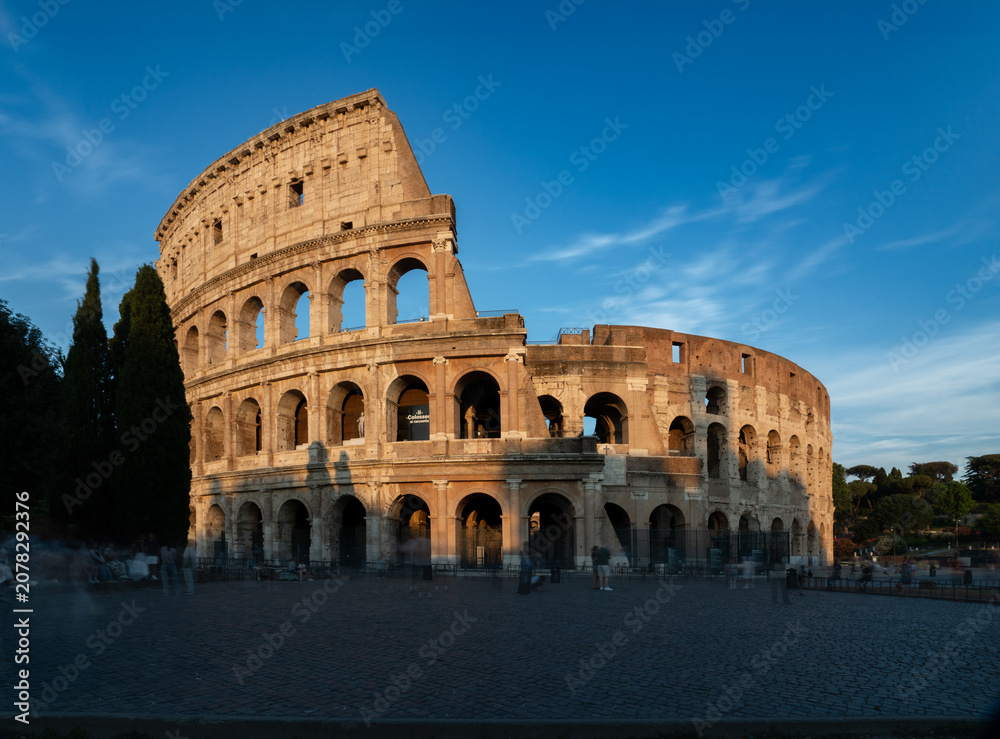 Naklejka premium The Colosseum at sunset in Rome, Italy 