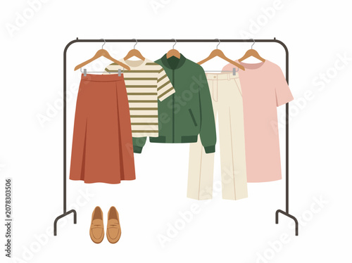 A stylish collection of fashionable clothing items displayed on a minimalist rack, showcasing modern fashion trends with a mix of colors and textures for outfit inspiration.