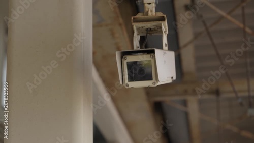 Box style security camera mounted on structure monitoring train station platform
