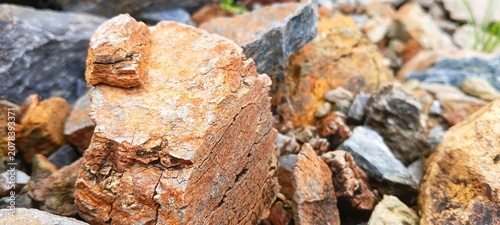 Canvas Print Large pile of raw mountain stones at a quarry site for heavy civil engineering,