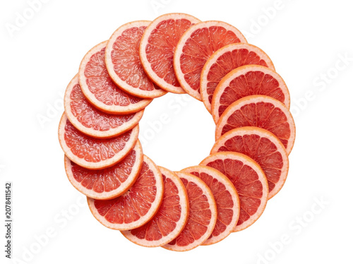A vibrant circular arrangement of sliced grapefruits on a white background