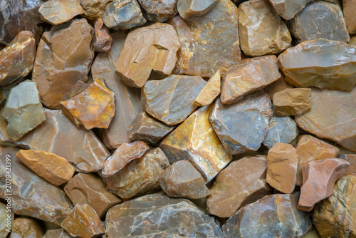 Abstract background of brown stones. Small pebbles, texture.