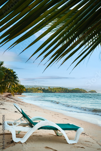 Empty beach chair on Las Ballenas Beach in Las Terrenas Samana, vertical format.
