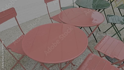 Video of steel tables and chairs on a rainy day