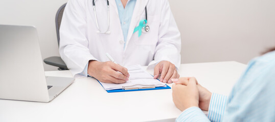 Doctor and patient having a medical consultation for Teal ribbon concept of September Ovarian Cancer Awareness month, PCOS, January Cervical Cancer, April Sexual Assault, June PSTD