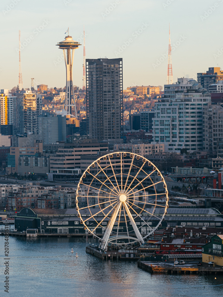 Fototapeta premium Seattle skyline with Space Needle and waterfront ferris wheel at sunset, urban cityscape, Washington USA. g.