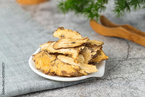 Bild auf Leinwand Dried Angelica Sinensis Slices on White Plate