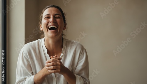 Joyful Woman Bursting into Authentic Laughter with Hands Clasped