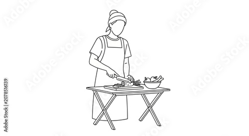 Chef preparing food on a portable table.