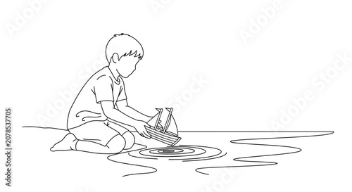 Child playing with paper boat in puddle.