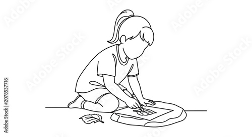 Young girl drawing on the floor with crayons.