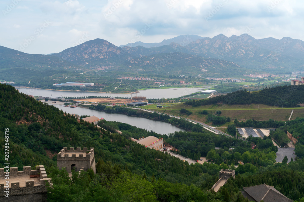 Fototapeta premium A Fragment of the Great Wall in the Nanshan scenic area of the Jiaodong Peninsula on a sunny summer day, Longkou, Yantai, Shandong, China
