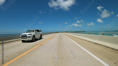 Driving a car on Florida Keys Highway Over Water ,  along a two lane highway built over a body of water in  Florida