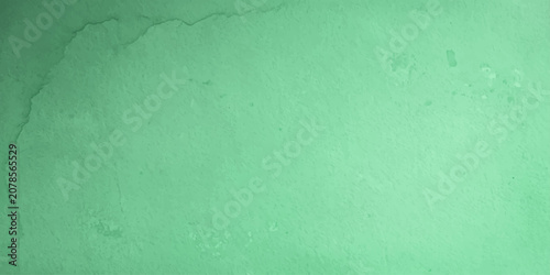 Fotografía A close-up abstract image showcases textured green surface with subtle water marks and small bubbles, creating an organic and atmospheric effect