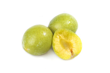 Fresh Yellow Green Plums Cut in Half Studio Shot on White Background