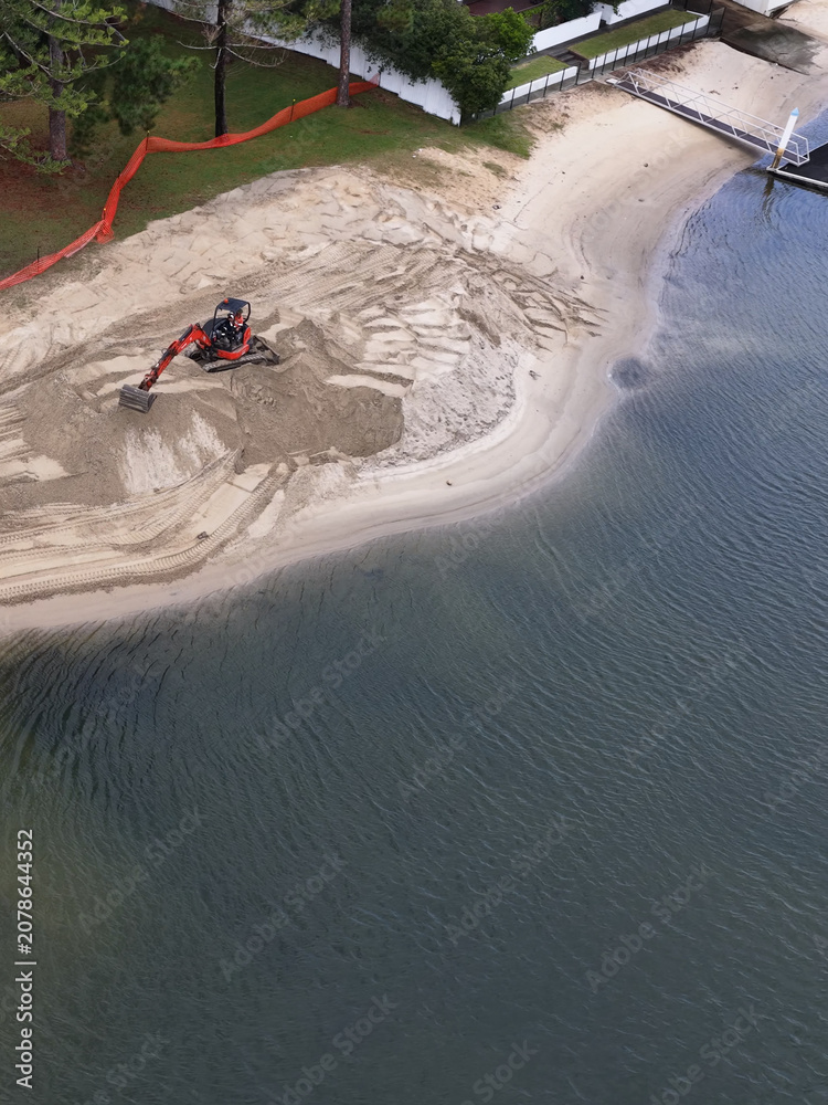 Fototapeta premium Aerial View of Excavator Moving Sand on Gold Coast Canal Beach