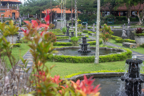 Beautiful manicured gardens with ponds and shrubs at Tirta Gangga water palace, Karangasem, East Bali, Indonesia.