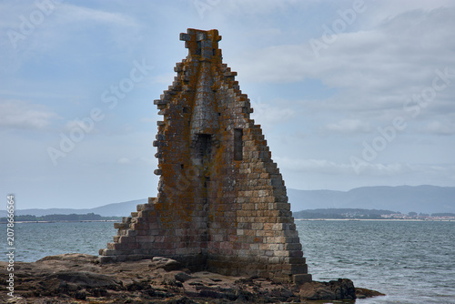 The ruins of the Tower of San Sadurnino rise above the sea on the islet of A Figueira, Cambados, Galicia