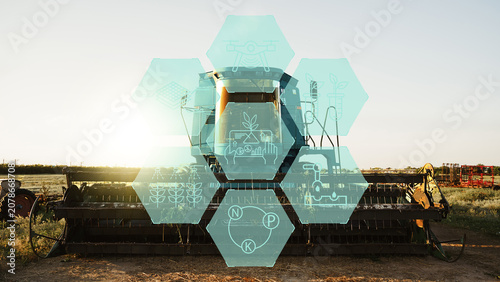Canvas Print Smart farm equipment with technology icons at sunset in agricultural field