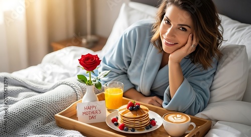 Woman in bed with mother's day breakfast tray