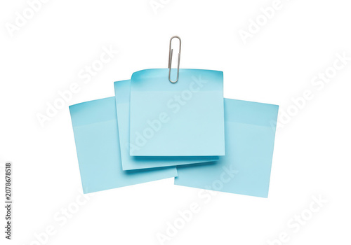 Three stacked light blue sticky notes held by a silver paperclip isolated on a transparent background