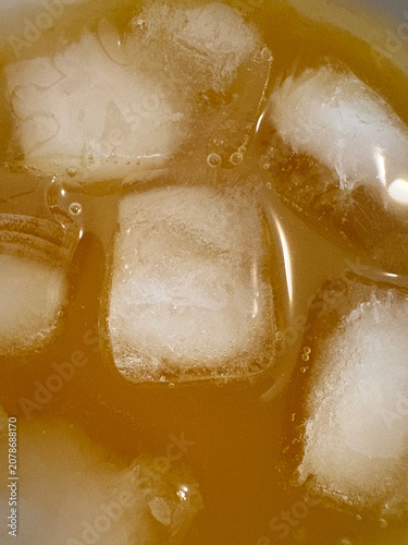 Close-Up of Ice Cubes in Cold Drink with Bubbles Macro View