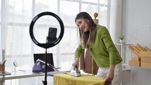Influencer ironing clothes while recording video content