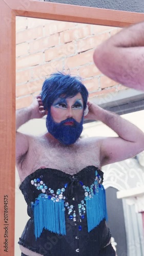 Bearded Drag Queen Prepares for Performance in Vibrant Outfit at Local Venue