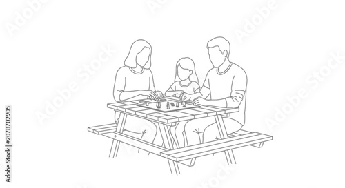 Family enjoying a picnic meal together outdoors.