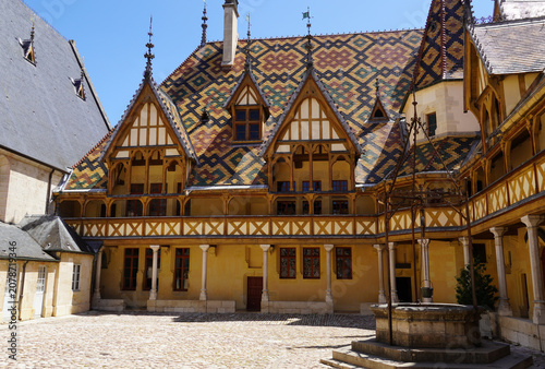 Hospices de Beaune’s building viewed from the inner courtyard, with its polychromatic glazed tile roofs. Beaune, Burgundy. France, June.