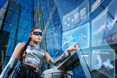 Futuristic girl interacting with holographic AR screen