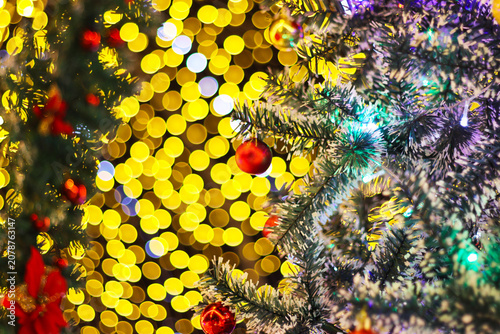 Warm yellow and red glowing bokeh lights background with vertical streaks creating cozy festive atmosphere
