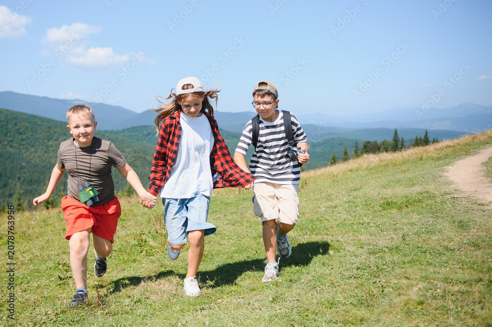 Fototapeta premium Children running on mountain top during summer vacation