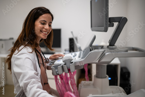 Female doctor performing ultrasonography using ultrasound machine
