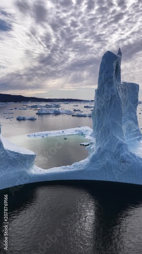 Massive iceberg wall towers over an arctic ocean