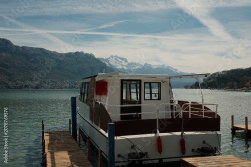 hite Passenger Boat Moored at a Wooden Pier