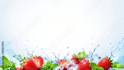 Fresh strawberry with mint leaf and ice cube in water splash. Ripe red berry with crystal clear liquid wave. Organic fruit, healthy nutrition, culinary ingredient and summer drink concept.