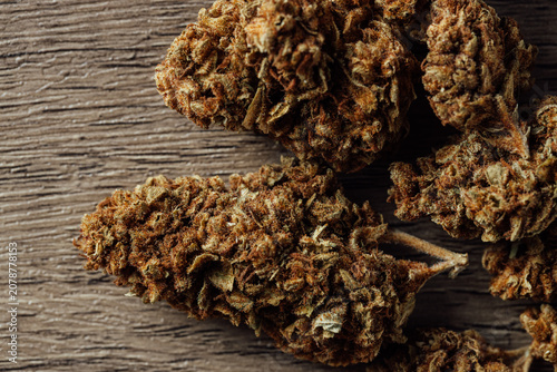 фотографія Close-up View of Dried Cannabis Buds on Rustic Wooden Surface