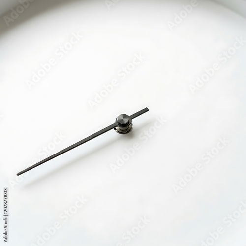 Close up of a silver ballpoint pen on white surface.