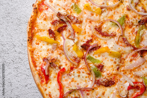 Bacon pizza with peppers onions mozzarella cheese and toppings