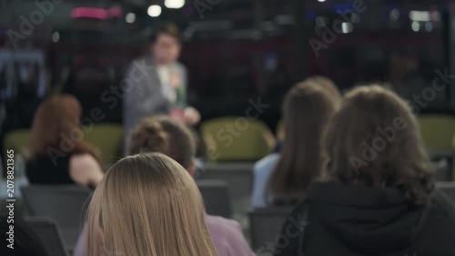 Business presentation in conference room, audience listening to speaker, professional workshop atmosphere, focus and engagement, corporate training session.