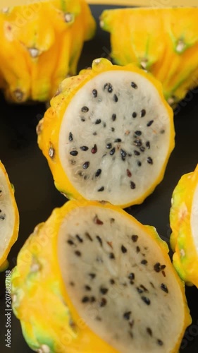 Cut ripe yellow pitahaya fruits close up view.