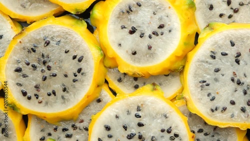Slices of yellow dragon fruit texture background top view