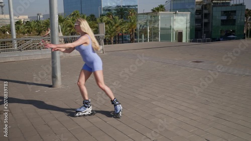 Blonde woman rollerskating outdoors in the city