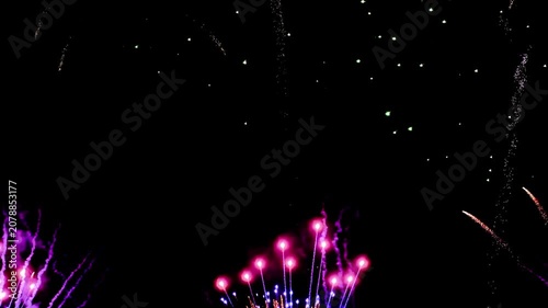 4K. loop seamless of real fireworks background golden shining fireworks with bokeh lights in the night sky. glowing fireworks show. New year's eve fireworks celebration multiple colors
