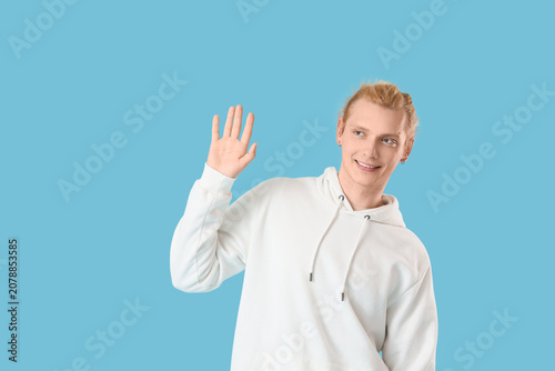 Young blonde man in white h...